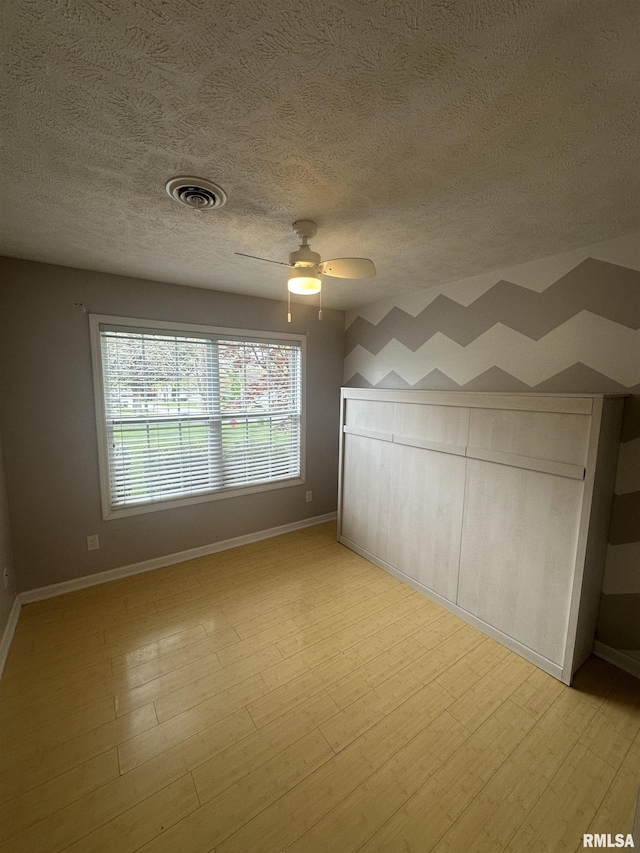 1000 N Almond St, Carbondale, IL 62901 - spare room with baseboards, visible vents, ceiling fan, and a textured ceiling