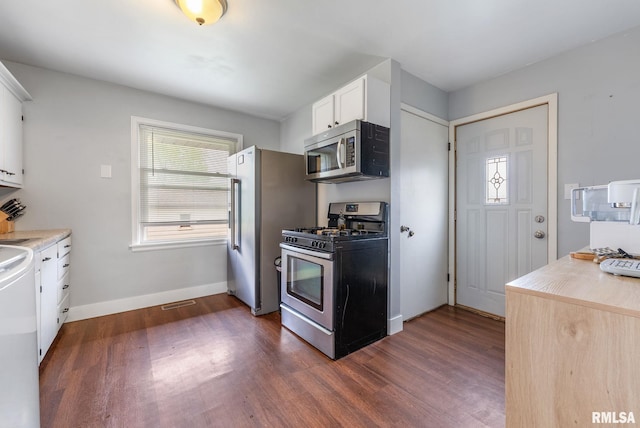 1925 N Fairmount St, Davenport, IA 52804 - kitchen featuring appliances with stainless steel finishes, light countertops, white cabinetry, baseboards, and dark wood-style floors