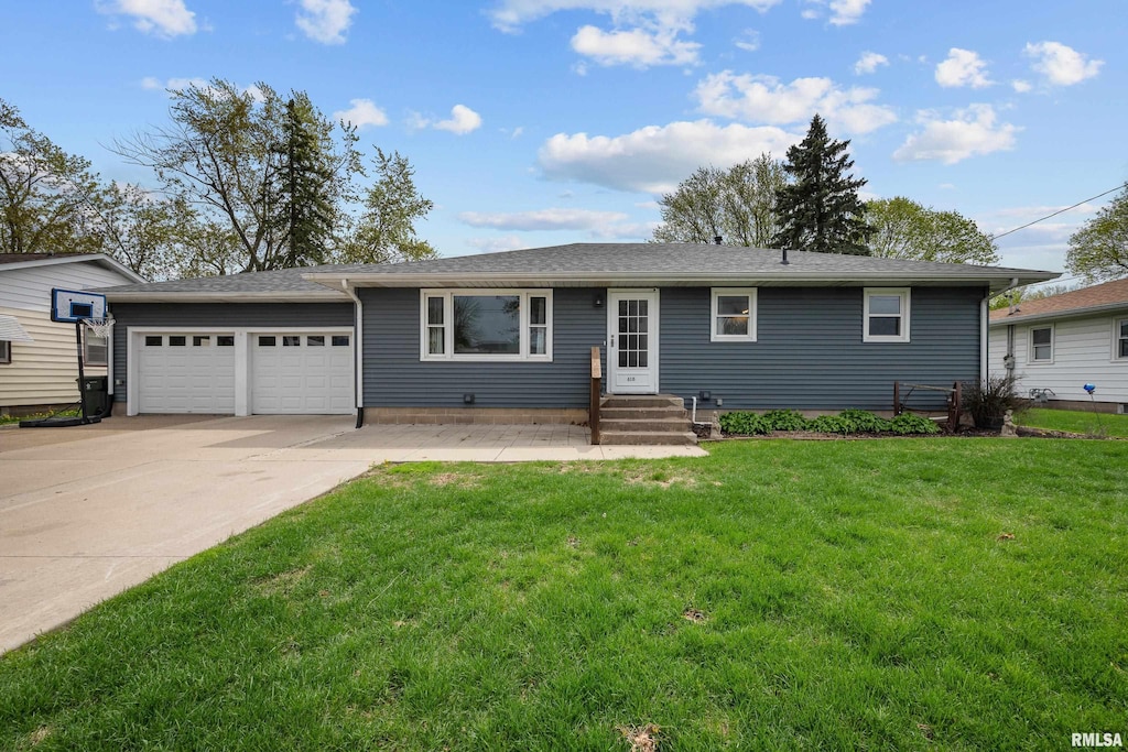 ranch-style home featuring entry steps, an attached garage, concrete driveway, and a front yard