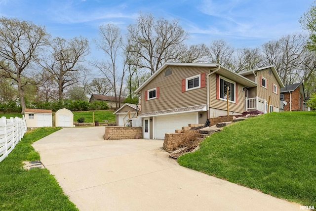 12323 Niabi Zoo Rd, Coal Valley, IL 61240 - view of side of home with driveway, a yard, an attached garage, and fence