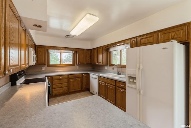 12323 Niabi Zoo Rd, Coal Valley, IL 61240 - kitchen featuring a sink, brown cabinets, a wealth of natural light, and white appliances