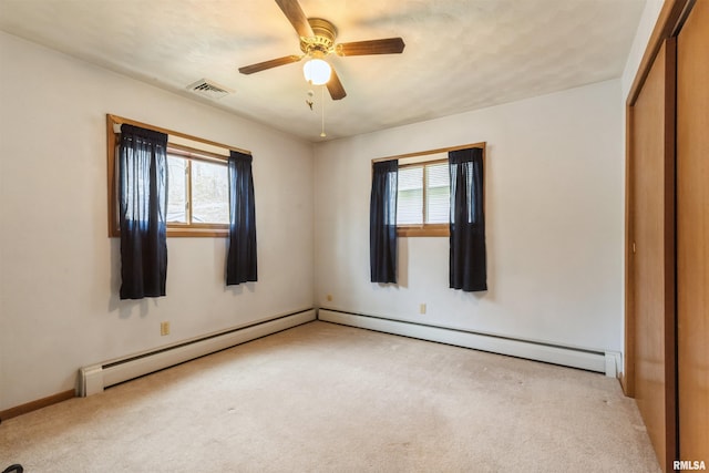 12323 Niabi Zoo Rd, Coal Valley, IL 61240 - unfurnished bedroom with carpet flooring, a closet, visible vents, and baseboard heating