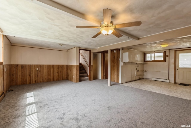 12323 Niabi Zoo Rd, Coal Valley, IL 61240 - interior space featuring wainscoting, baseboard heating, stairway, a ceiling fan, and wooden walls