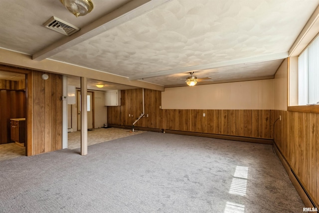 12323 Niabi Zoo Rd, Coal Valley, IL 61240 - basement featuring visible vents, baseboard heating, wood walls, and carpet