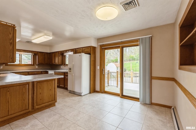 12323 Niabi Zoo Rd, Coal Valley, IL 61240 - kitchen featuring light countertops, white fridge with ice dispenser, visible vents, baseboards, and baseboard heating