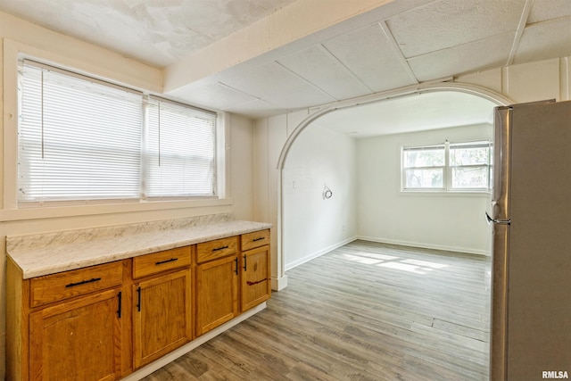737/739 24th St, East Moline, IL 61244 - interior space featuring arched walkways, baseboards, and light wood finished floors