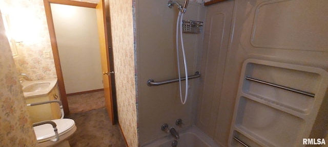 bathroom featuring vanity, toilet, baseboards, and bathing tub / shower combination