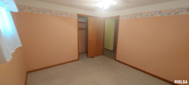 unfurnished bedroom featuring a closet and light carpet