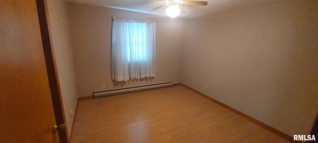 empty room with light wood-type flooring, a ceiling fan, baseboard heating, and baseboards