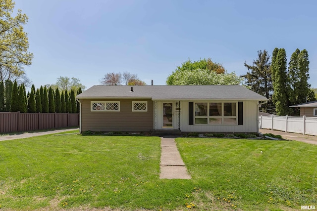 view of front of house featuring fence and a front yard