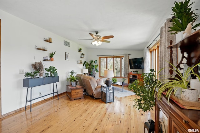 interior space featuring baseboards, ceiling fan, and light wood-style flooring