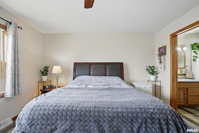 bedroom featuring wood finished floors, a ceiling fan, and visible vents