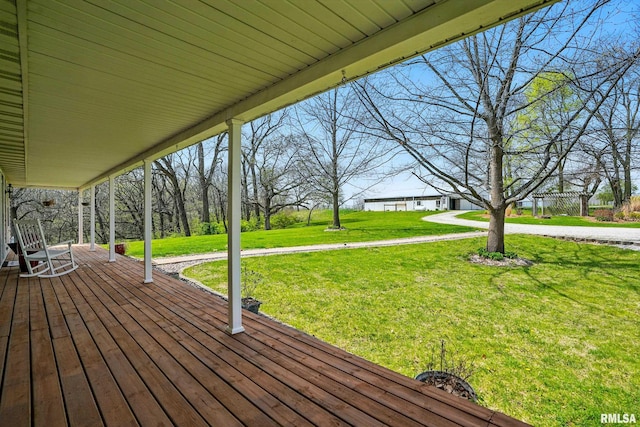 wooden deck featuring a yard