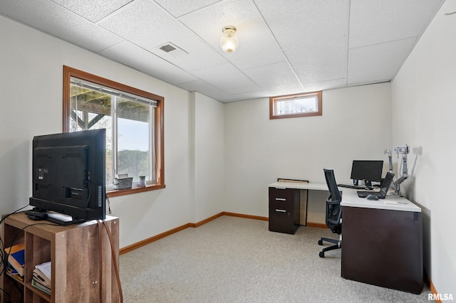 office space featuring visible vents, a drop ceiling, light colored carpet, and baseboards