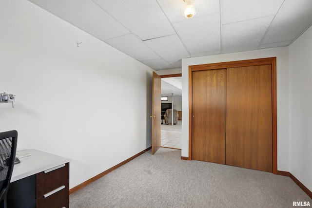 unfurnished bedroom with light colored carpet, a closet, and baseboards