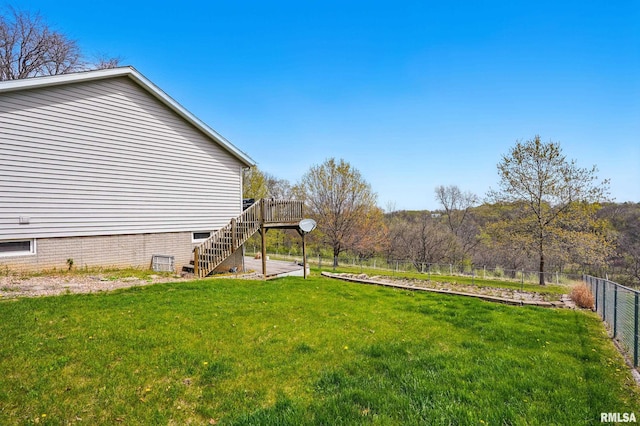 view of yard with fence, stairs, and a wooden deck