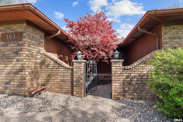 view of property exterior with a gate