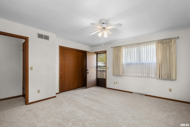 unfurnished bedroom featuring carpet flooring, a closet, visible vents, and baseboards
