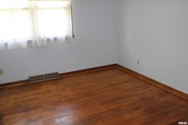 2107 W 38th Pl, Davenport, IA 52806 - unfurnished room featuring visible vents, baseboards, and wood finished floors