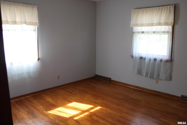 2107 W 38th Pl, Davenport, IA 52806 - spare room featuring baseboards, wood finished floors, and visible vents