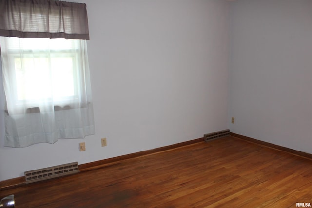 2107 W 38th Pl, Davenport, IA 52806 - unfurnished room featuring baseboards, visible vents, and wood finished floors