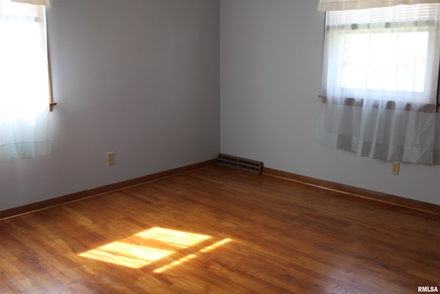 2107 W 38th Pl, Davenport, IA 52806 - unfurnished room with baseboards, visible vents, and wood finished floors