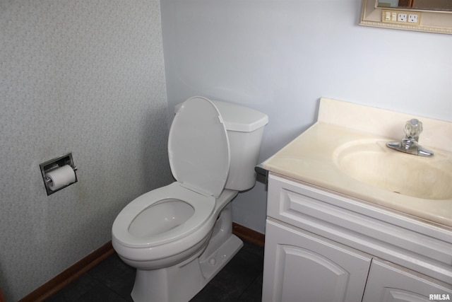 2107 W 38th Pl, Davenport, IA 52806 - half bath with toilet, baseboards, wallpapered walls, and vanity