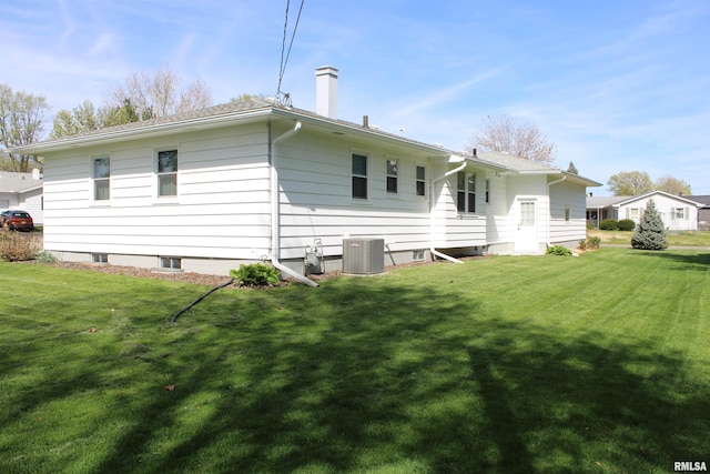 2107 W 38th Pl, Davenport, IA 52806 - back of property with central AC, a yard, and a chimney