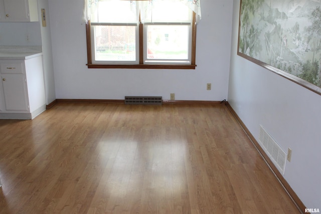 2107 W 38th Pl, Davenport, IA 52806 - spare room featuring baseboards, visible vents, and light wood finished floors