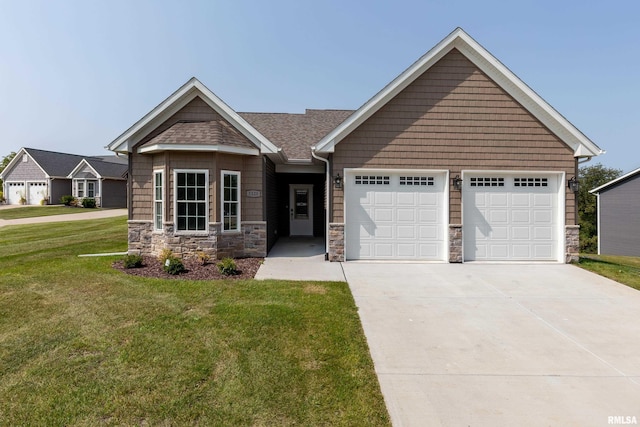 5120 Pandit Dr, Bettendorf, IA 52722 - craftsman inspired home featuring a front lawn, concrete driveway, an attached garage, and stone siding