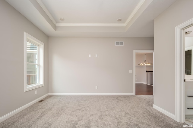 5120 Pandit Dr, Bettendorf, IA 52722 - carpeted empty room featuring a notable chandelier, visible vents, a tray ceiling, and baseboards