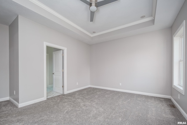 5120 Pandit Dr, Bettendorf, IA 52722 - carpeted empty room featuring baseboards, a raised ceiling, a ceiling fan, and crown molding