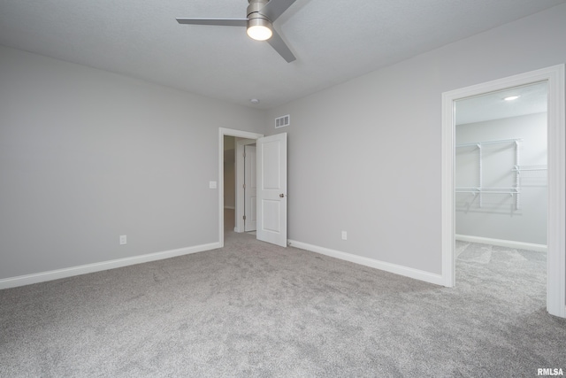 5120 Pandit Dr, Bettendorf, IA 52722 - unfurnished bedroom featuring a walk in closet, visible vents, carpet, and baseboards