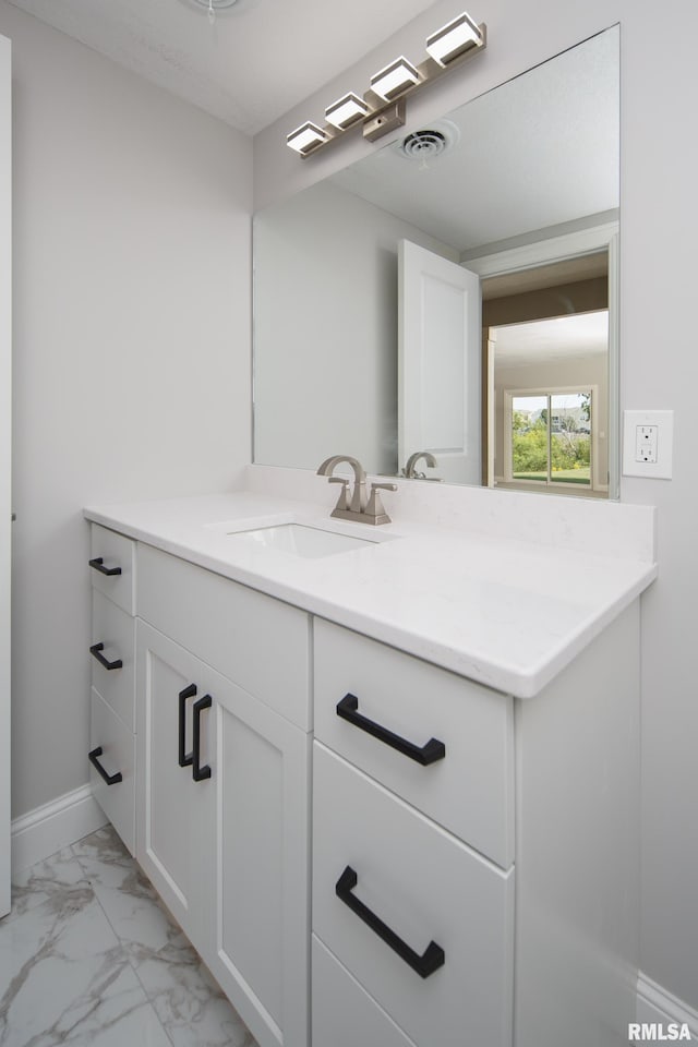 5120 Pandit Dr, Bettendorf, IA 52722 - bathroom featuring marble finish floor, visible vents, vanity, and baseboards