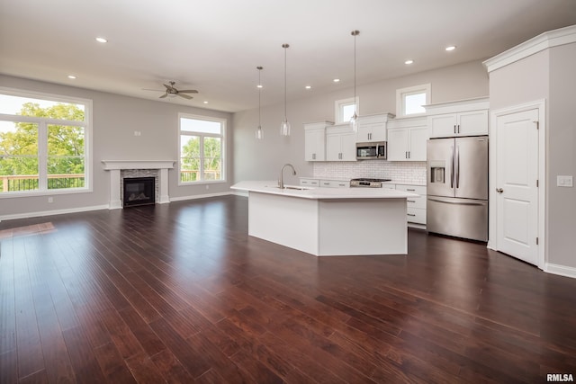 5120 Pandit Dr, Bettendorf, IA 52722 - kitchen with appliances with stainless steel finishes, light countertops, ceiling fan, a sink, and open floor plan