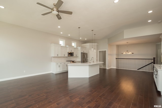 5120 Pandit Dr, Bettendorf, IA 52722 - unfurnished living room with baseboards, recessed lighting, ceiling fan with notable chandelier, and a sink