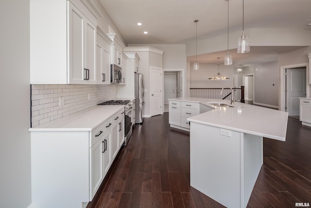 5120 Pandit Dr, Bettendorf, IA 52722 - kitchen featuring decorative backsplash, a sink, stainless steel appliances, a large island, and dark wood finished floors