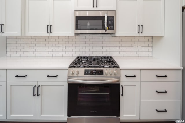 5120 Pandit Dr, Bettendorf, IA 52722 - kitchen featuring white cabinetry, tasteful backsplash, stainless steel appliances, and light countertops