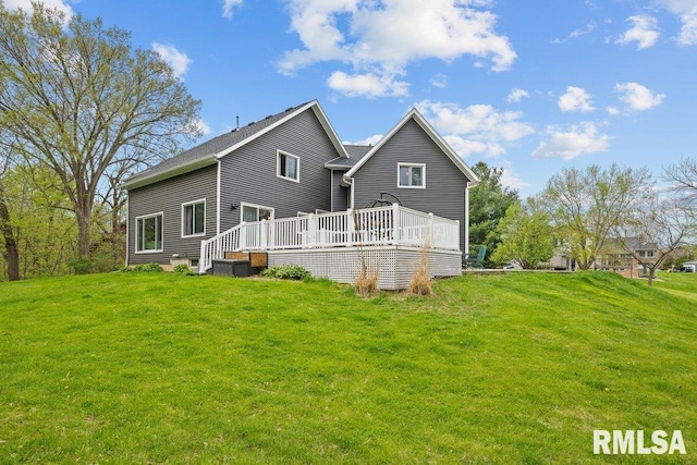 back of property featuring a yard and a deck