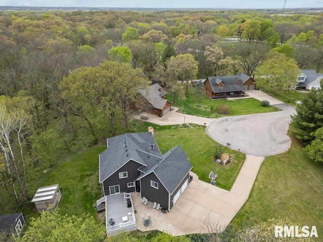 drone / aerial view with a wooded view