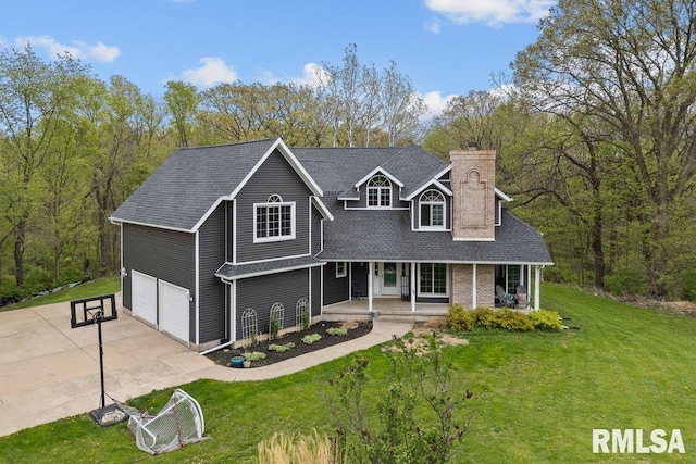 traditional-style house with covered porch, an attached garage, driveway, and a front lawn