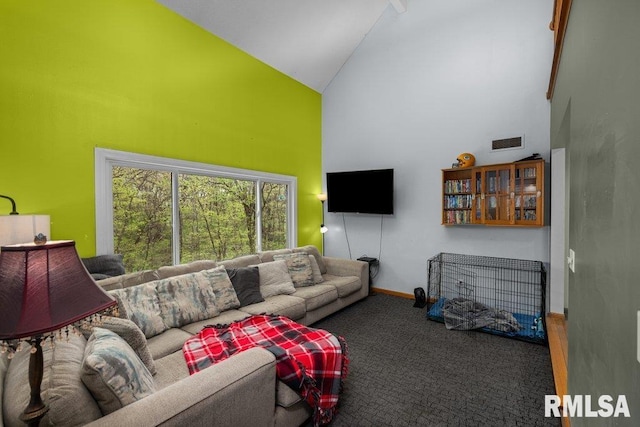 living room with high vaulted ceiling, baseboards, carpet floors, and visible vents