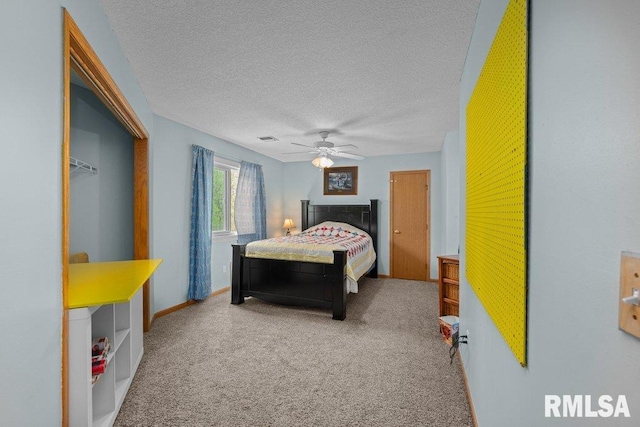 carpeted bedroom featuring a textured ceiling, visible vents, and ceiling fan