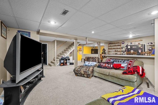 living room featuring carpet flooring, visible vents, and a paneled ceiling