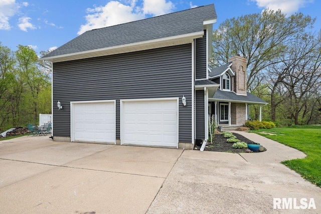 view of property exterior with roof with shingles, a chimney, concrete driveway, and a porch