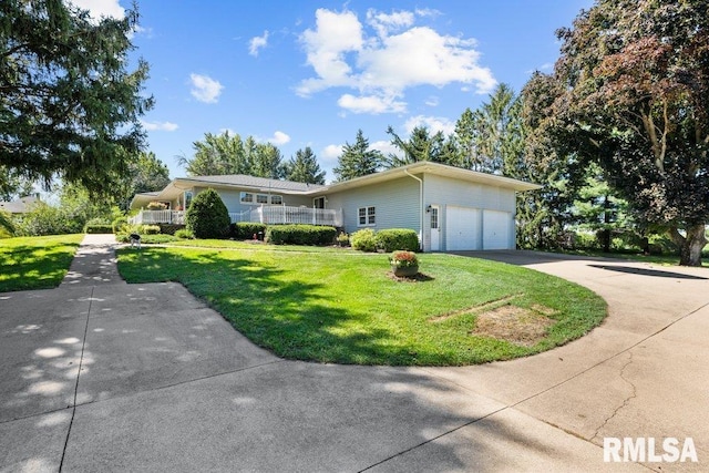 view of front facade with a front lawn, driveway, and an attached garage