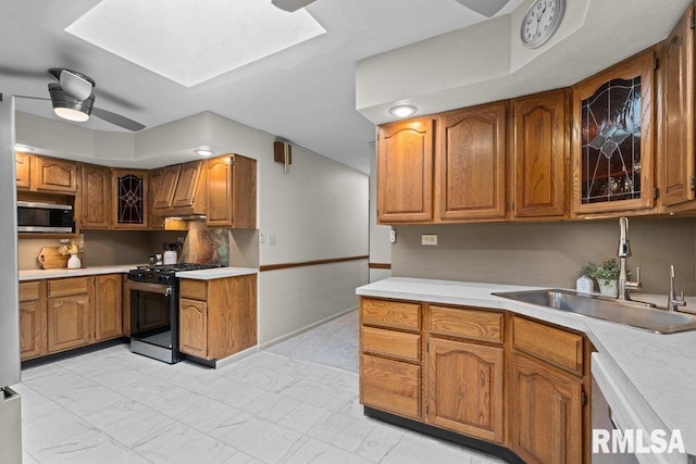 kitchen featuring a sink, brown cabinets, and stainless steel appliances