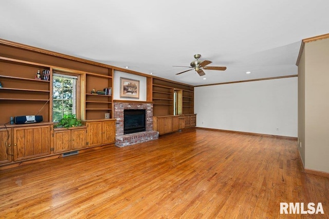 unfurnished living room with light wood-style flooring, ceiling fan, baseboards, visible vents, and crown molding
