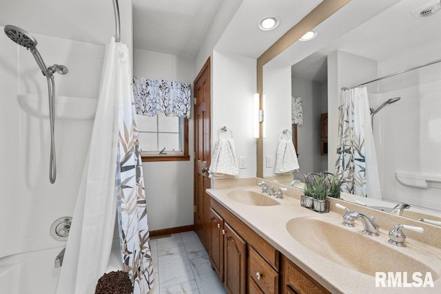 full bathroom with double vanity, a sink, baseboards, and visible vents