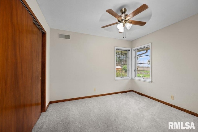 unfurnished bedroom with visible vents, a closet, baseboards, carpet, and a ceiling fan